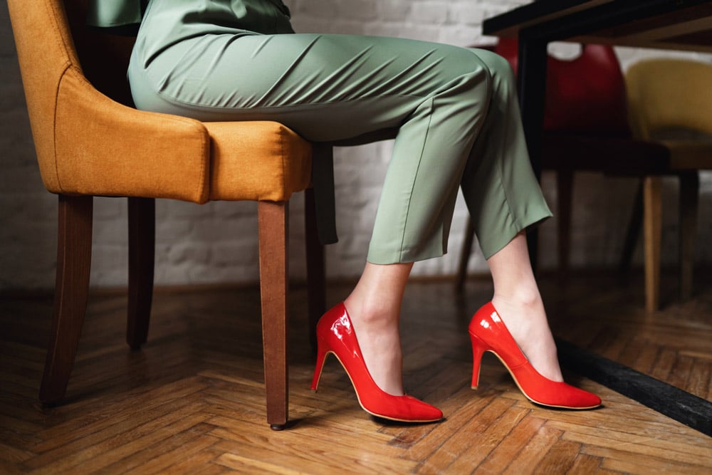 Woman wearing high heels while sitting.