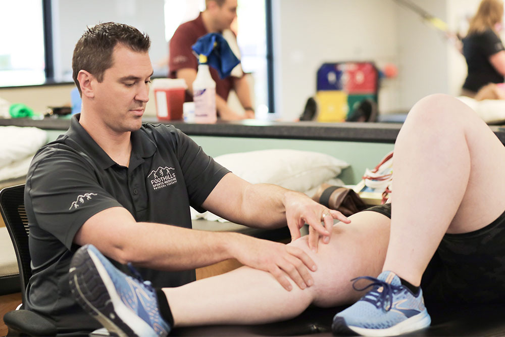 Physical Therapist examining a patients knee.
