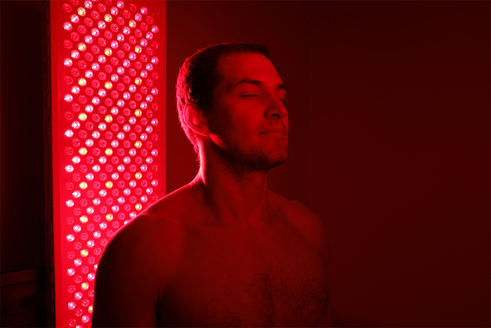 Athlete using red light therapy for recovery.