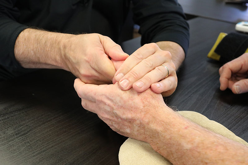 Therapist working on patients hand