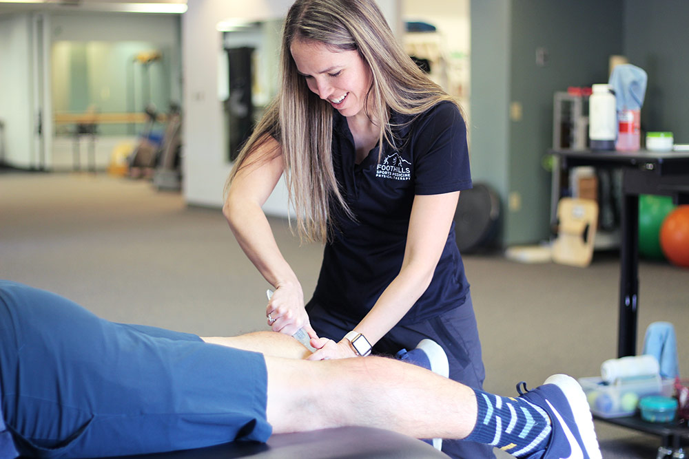 Physical Therapist using scraping tool to promote healing.