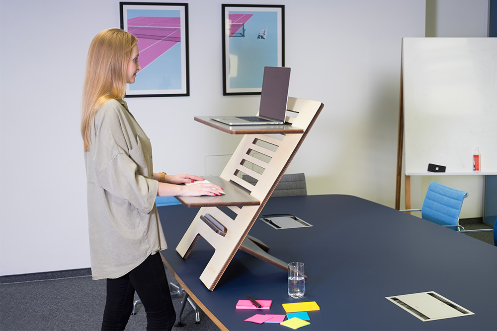 Woman using standing desk with excellent posture.