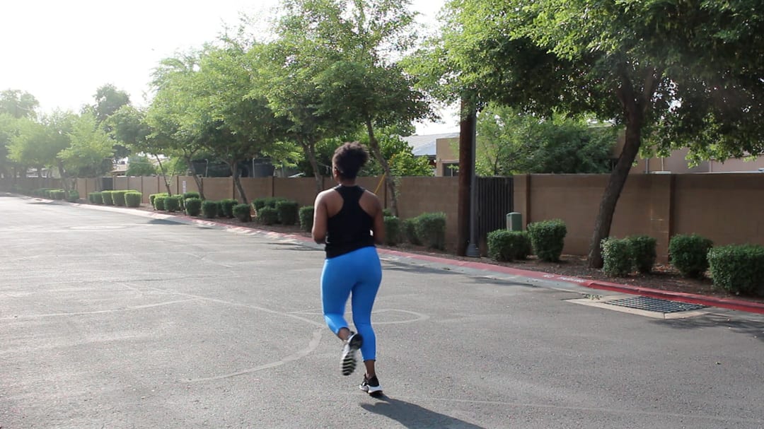 woman running outside after success with her telehealth physical therapy