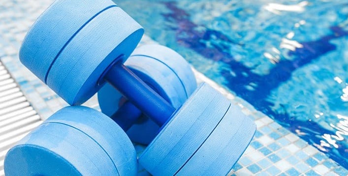 Aquatic Therapy hand weights on a pool deck