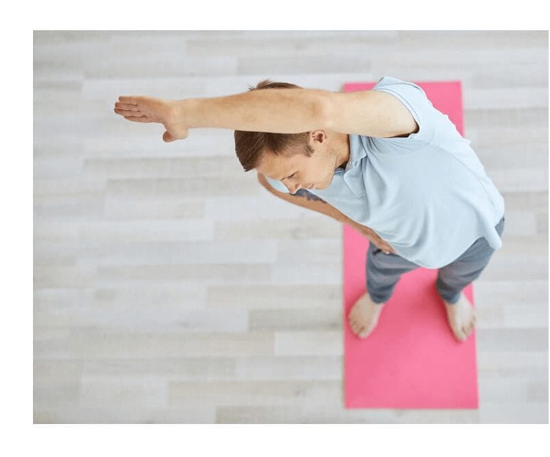 Man stretching on yoga mat