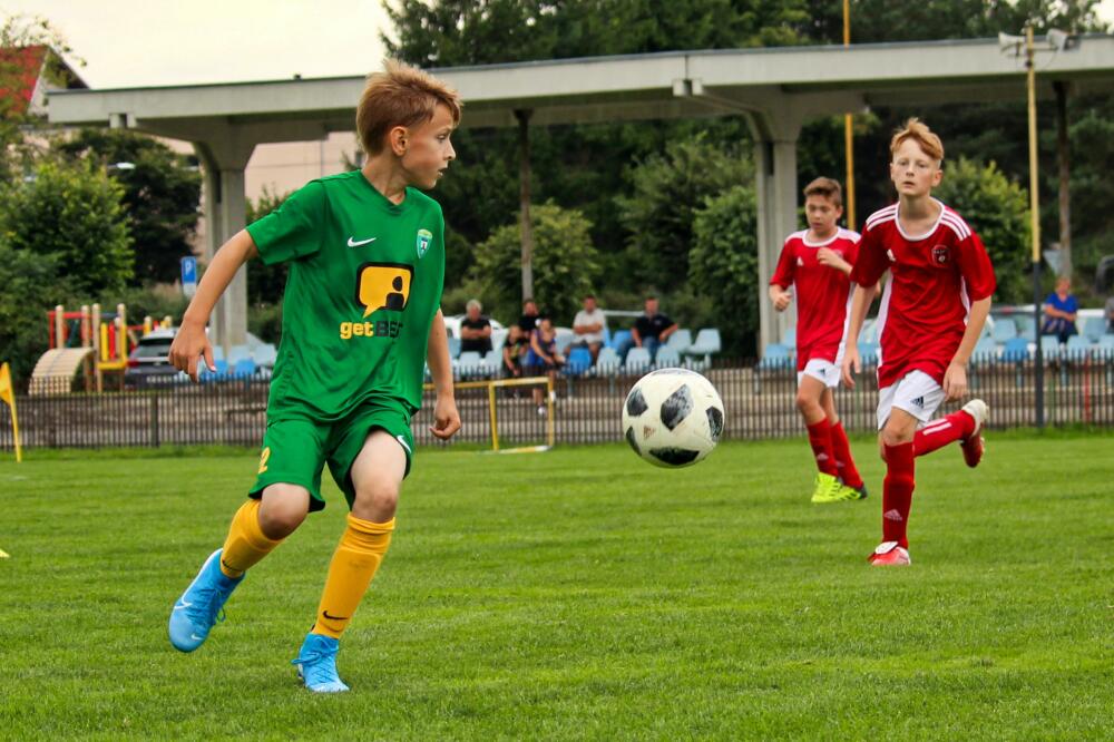 Youth athletes on the field playing soccer.