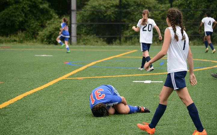 Youth soccer athlete injured on the field.