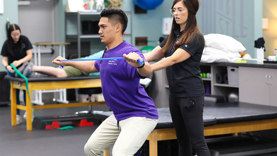 Physical therapist helping patient with balance and coordination.