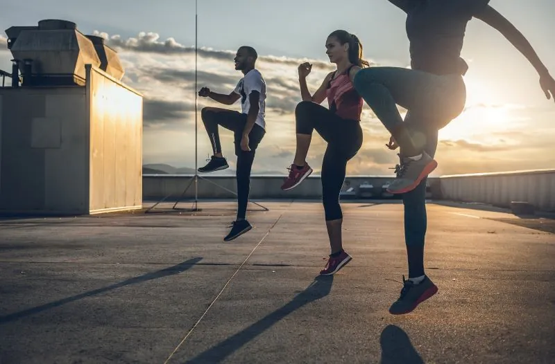 Athletes running in place outside.