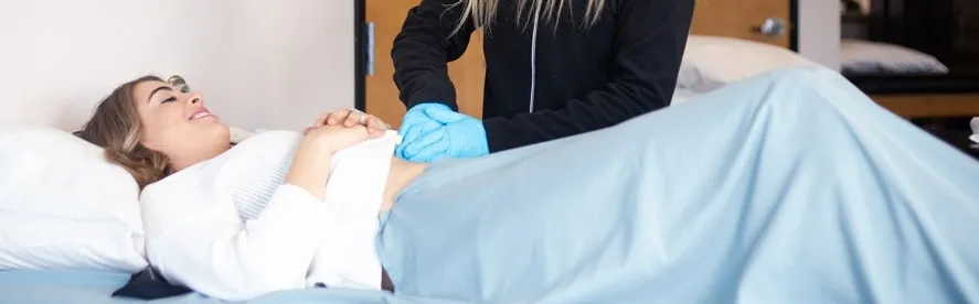 Physical therapist giving patient pelvic floor treatment.
