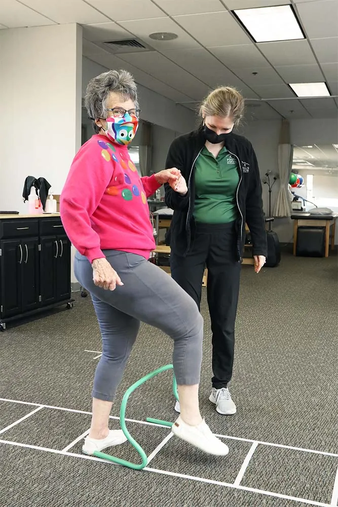 PT, helping client improve balance.