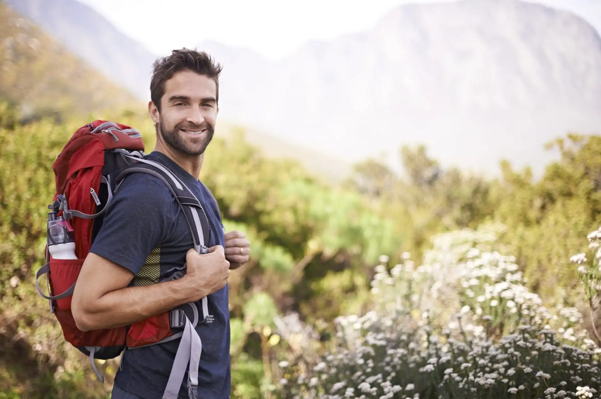 Man hiking in Arizona smiling at camera.