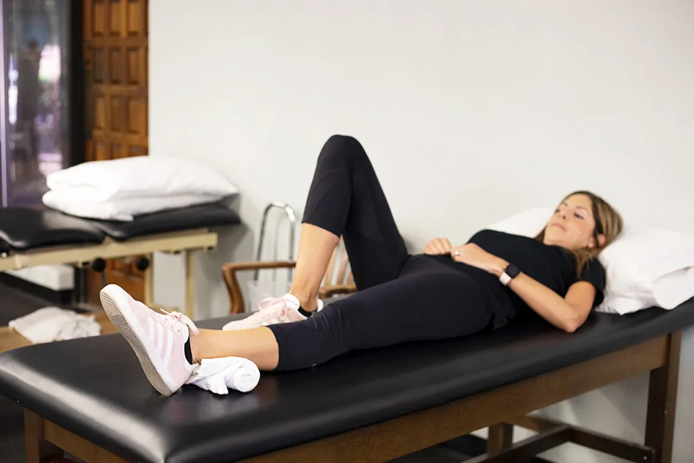 PT, Melissa Miller demonstrating ankle pump exercise.