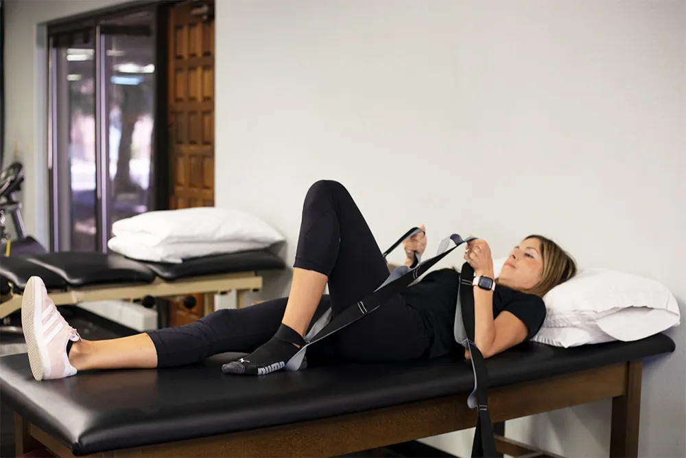 PT, Melissa Miller demonstrating heel slide exercise.