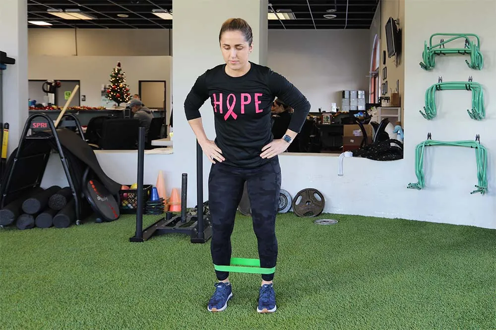 PT, Morgan demonstrating lateral walk exercise.