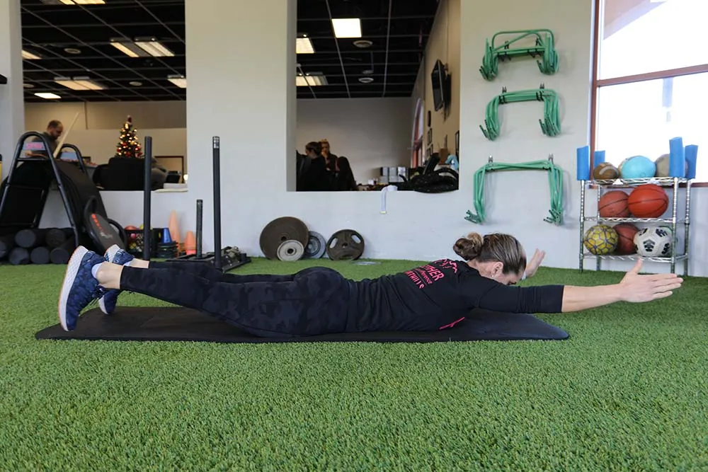 PT, Morgan demonstrating superman exercise.