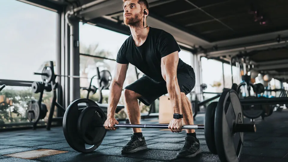Man lifting weights in gym.