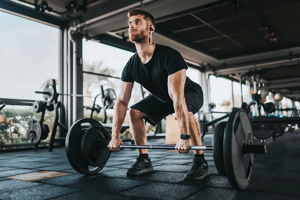 Man lifting weights in gym.