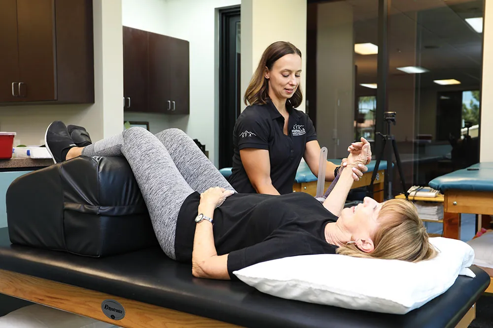 PT, treating clients shoulder pain.