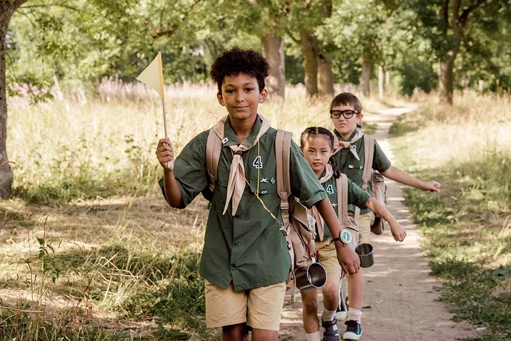 Children walking in a line at summer camp.