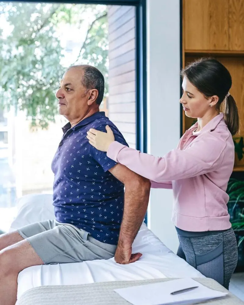 PT, examining patients back.