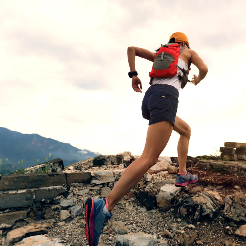 Hiker sprinting up mountain