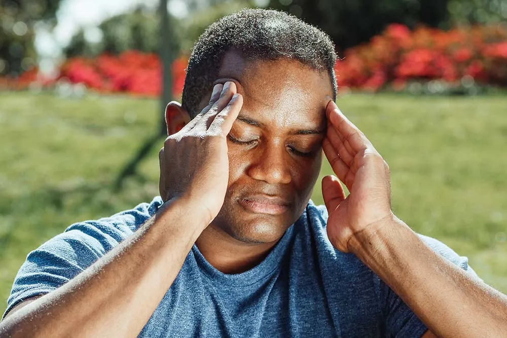 Man suffering headache.