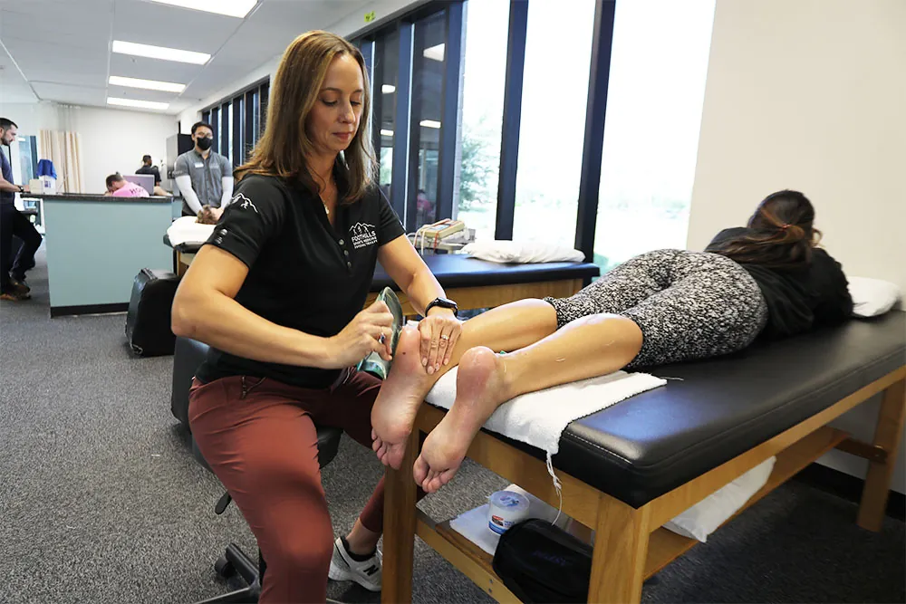 PT using IASTM treatment on patients foot.