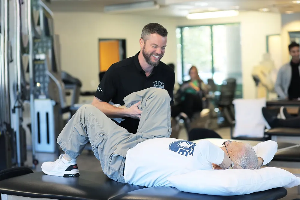 Physical therapist working on patients knee.