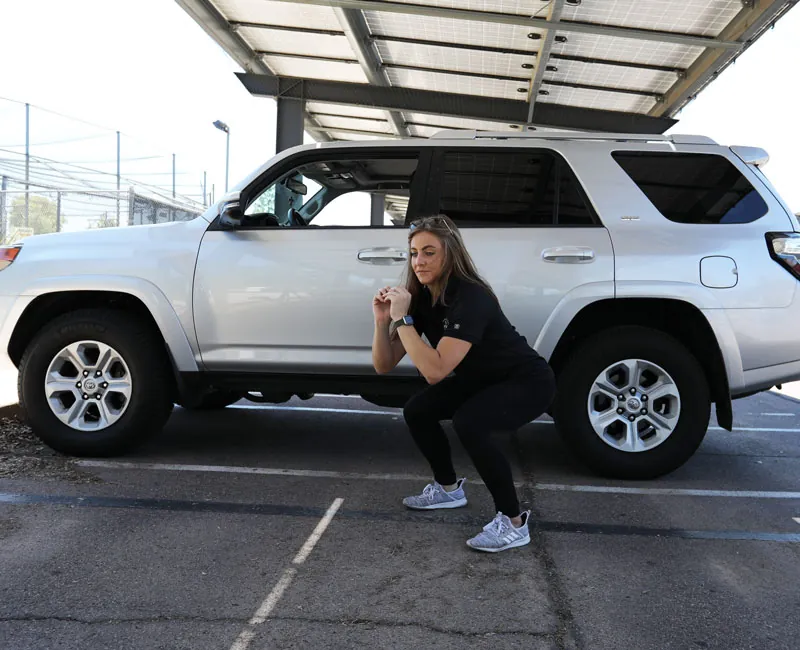 Squat stretch for long-distance driving.