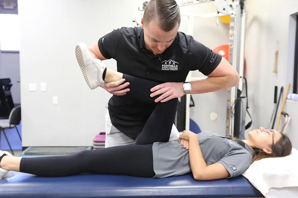 Chris Adam performing hip scour test