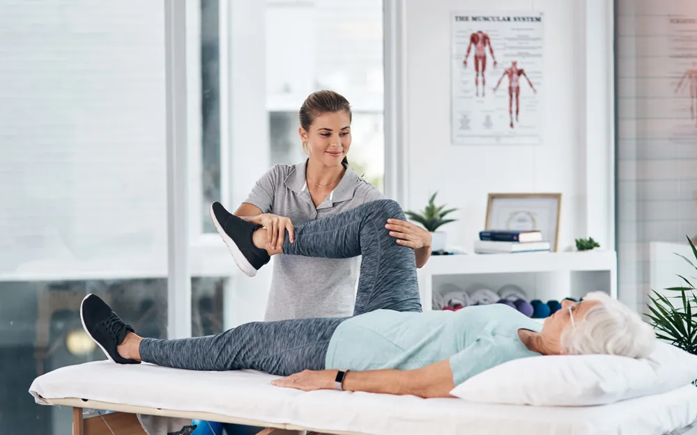 Physical therapist assessing patients leg strength