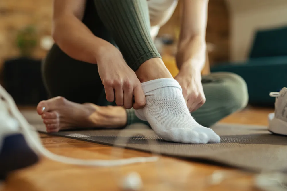 Woman putting on socks
