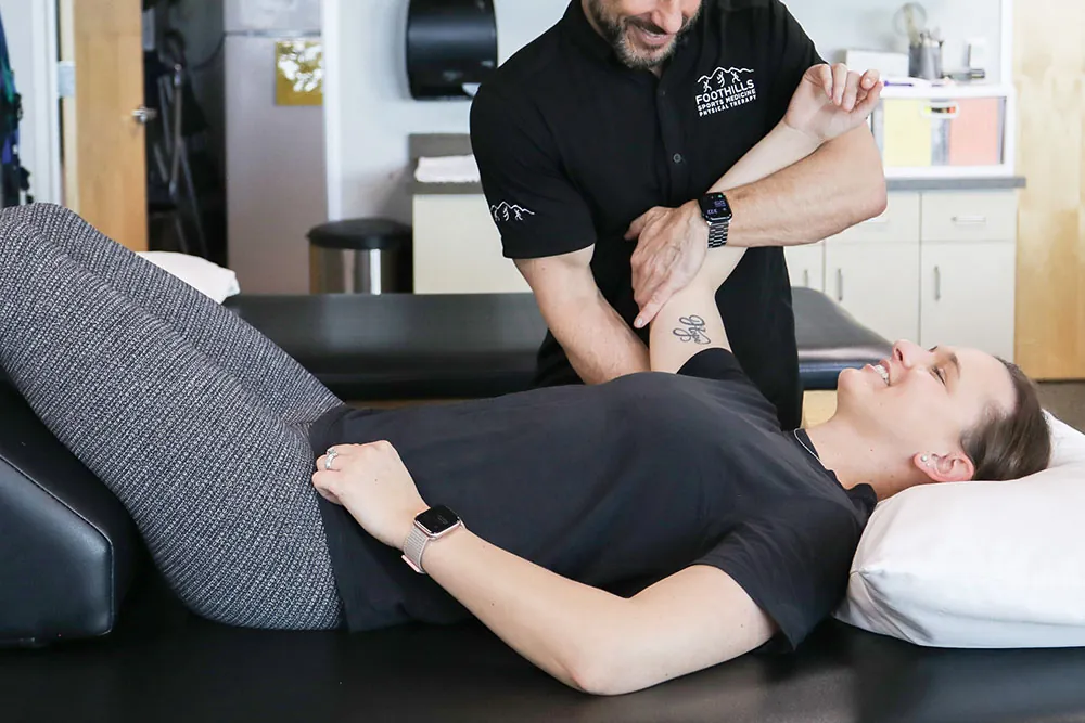 Physical therapist treating patient in promoting tissue healing.