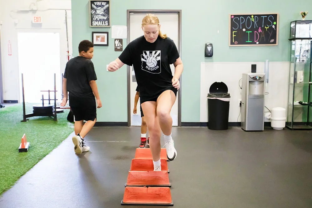 Young female athlete performing a single-leg jump.