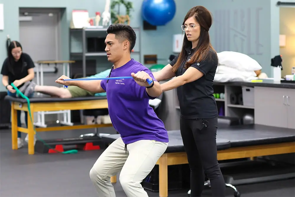 Physical therapist helping patient with balance and coordination.