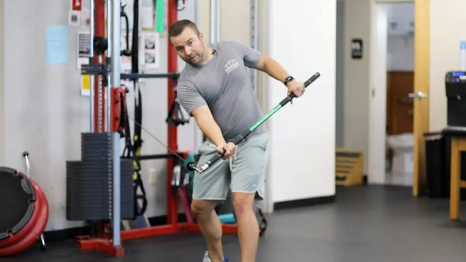Anthony demonstrating resisted back swing exercise.