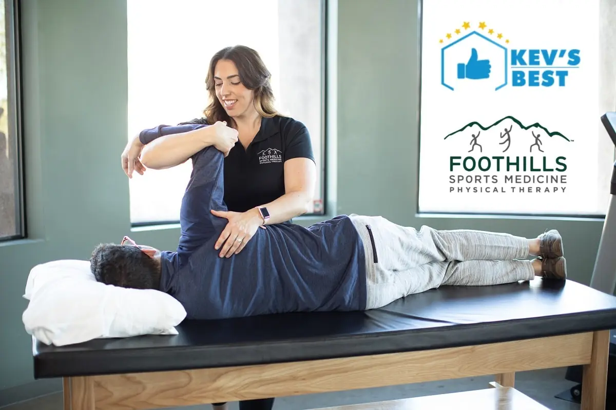 Physical Therapist working on a patients shoulder.